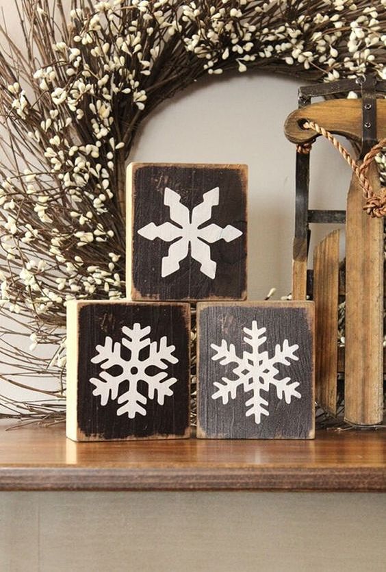 rustic christmas decor with a vine and willow wreath, wooden blocks with snowflakes painted is awesome