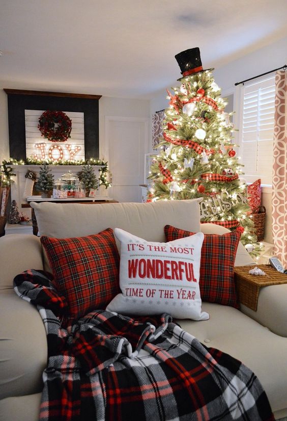 several plaid touches for a holiday feel - pillows, ribbon on the Christmas tree and a blanket for much coziness