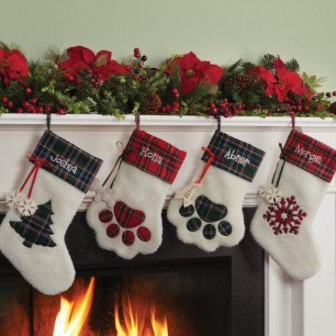 usual and paw-shaped plaid stockings are amazing to style your mantel for Christmas, add evergreens and pinecones and go