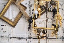 vintage gilded frames including one with gold and black ornaments hanging for lovely Christmas decor and a bold touch