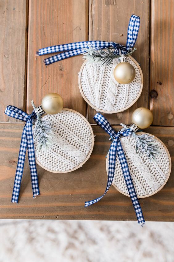 white braided knit ornaments with embroidery hoops, plaid ribbons, evergreens and gold ornaments are a great wya to upcycle an old sweater