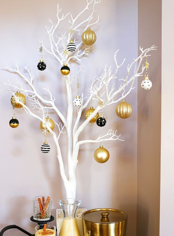 white branches and black, white and gold Christmas ornaments with various patterns is a lovely idea for holidays