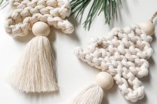 white knit Christmas ornaments with oversized wooden beads and tassels are amazing Christmas ornaments you can make yourself