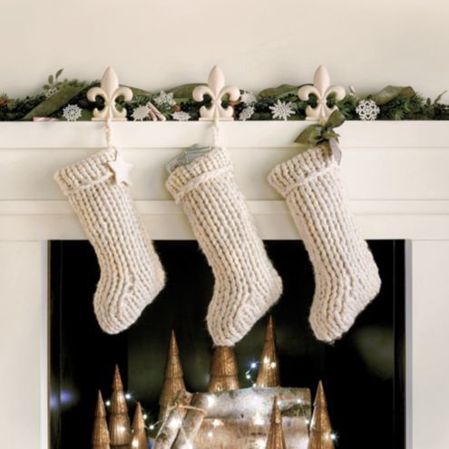 white knit stockings attached to a mantel will instantly make it feel like Christmas and you may personalize each of them