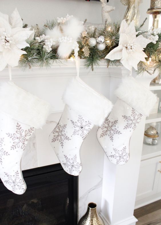 white stockings with snowflakes painted and white faux fur are amazing for Christmas decor done in neutrals and in white