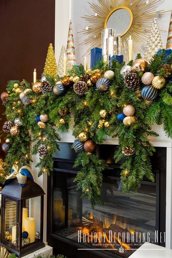 a colorful Christmas garland of evergreens, blue and gold ornaments, snowy pinecones is perfect for a mantel