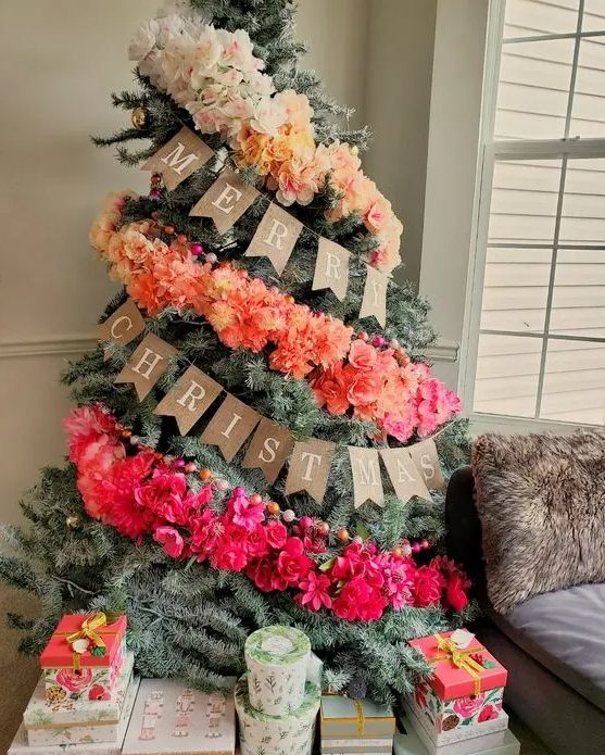 a fantastic ombre Christmas tree decorated with an ombre faux floral garland and colorful wooden beads is a lovely and bold idea