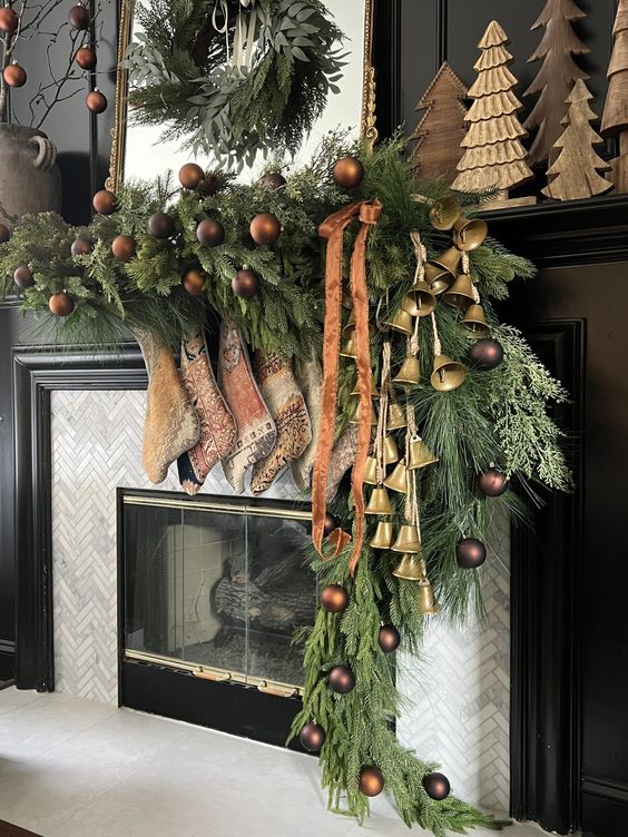 a gorgeous Christmas garland of evergreens, chocolate brown ornaments, large bells and printed stockings