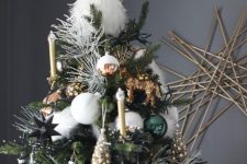 a gorgeous woodland Christmas tree with gilded candles, green, silver, white and copper ornaments, little animal figurines and a faux owl tree topper