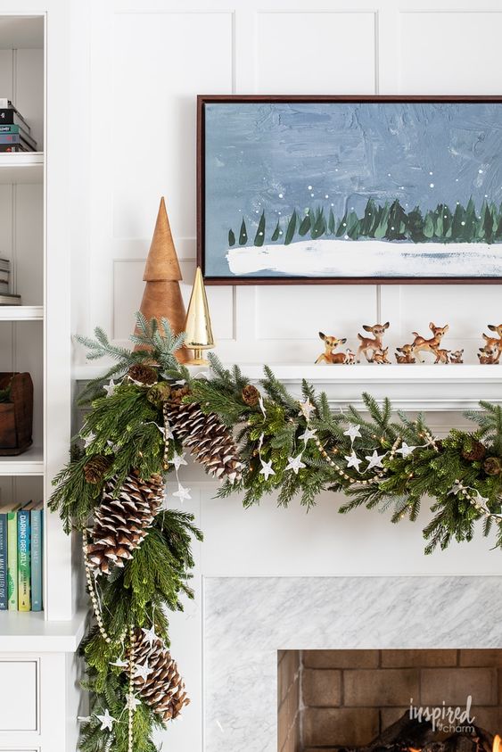 a pretty Christmas garland of evergreens, white stars, beads and snowy pinecones is a cool decoration for the mantel