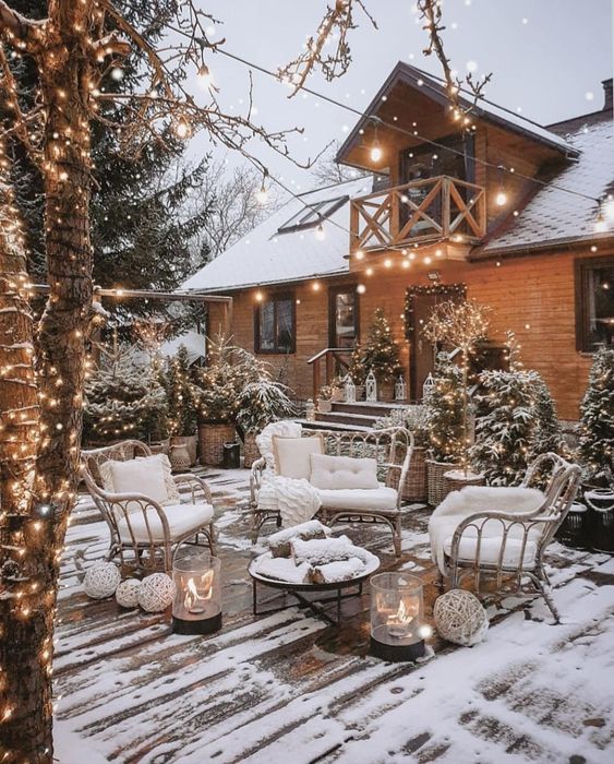 a simple and cozy winter terrace with wicker chairs, a fire bowl, mobile fireplaces and yarn balls is amazing