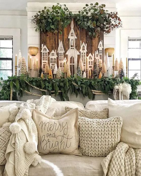 farmhouse Christmas decor with greenery, evergreens, mini Christmas trees, candles and other stuff
