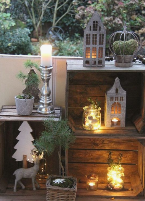 pretty winter balcony decor with crates, candle lanterns, moss and evergreens, deer and plywood trees