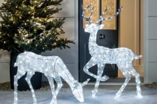 vine and light deer figurines and a lit up Christmas tree for gorgeous festive outdoor decor at Christmas