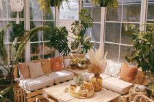 a cozy sunroom with pallet furniture