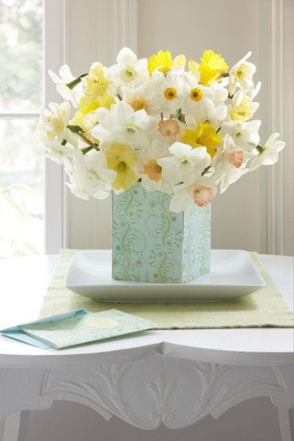 a blue vase with yellow and white daffodils is a classic spring flower arrangement that you may compose