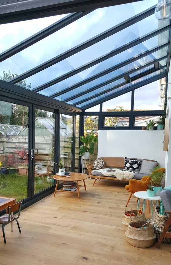 a chic mid-century modern attic space with elegant furniture, tables, baskets and bright pillows and plants