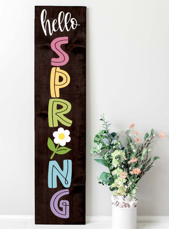 a dark stained wooden plaque sign with colorful letters and a bloom is a simple and cool idea for spring