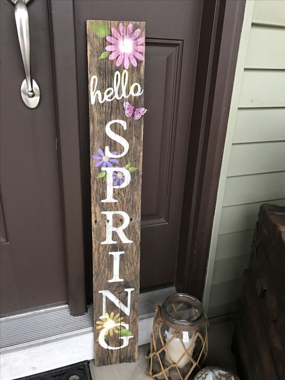 a rustic wooden sign with bright blooms and white letters is great for both indoors and outdoors