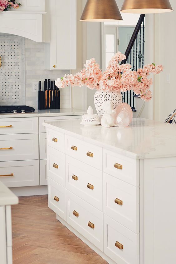 pink silk blooming branches is a chic centerpiece in a white vase, for a modern space