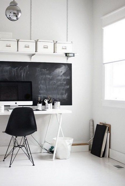 a Nordic home office mostly in white, with a chalkboard statement that can be used as a memo board