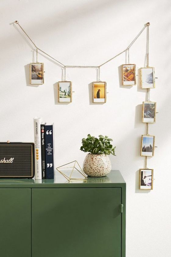 a chain with picture frames and photos in them is a creative and out-of-the-box display idea for your home