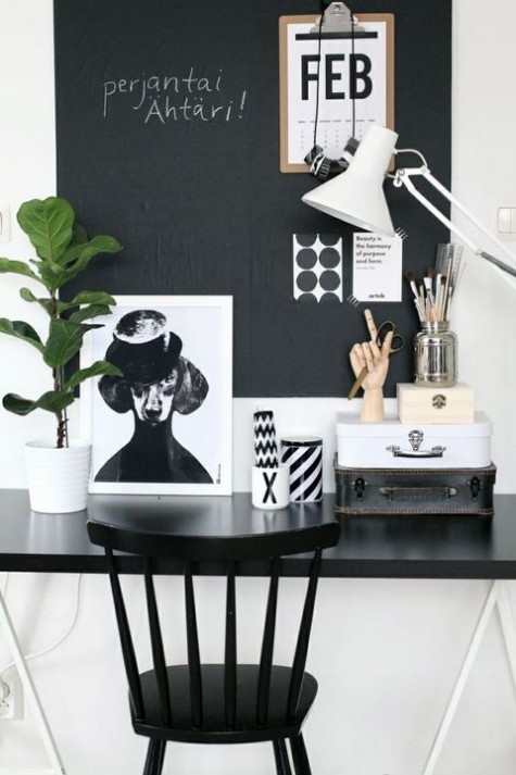 a monochromatic home office with a chalkboard wall used as a memo board - for making notes, for attaching stickers and other stuff