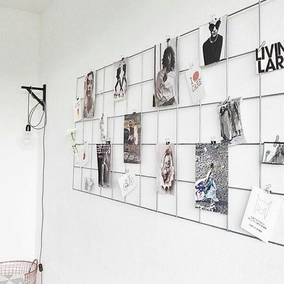 a simple metal grid on the wall will allow you to attach any photos you want to it and change them anytime