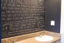 a sink space with a chalkboard wall with some fun art and graffiti instead of a mirror is a super creative idea