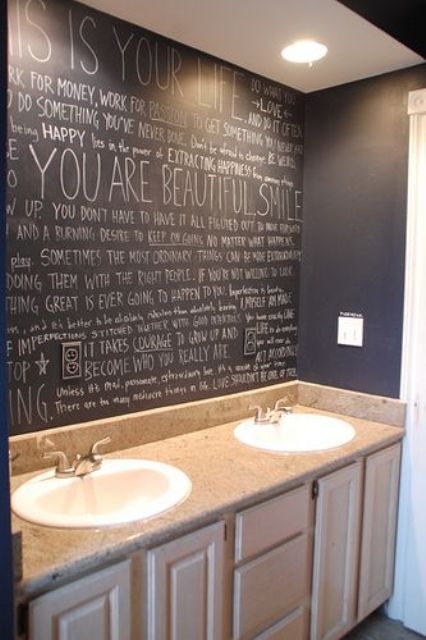 a sink space with a chalkboard wall with some fun art and graffiti instead of a mirror is a super creative idea