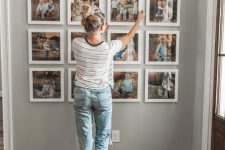a stylish family gallery wall with color photos in matching white frames is a timeless idea