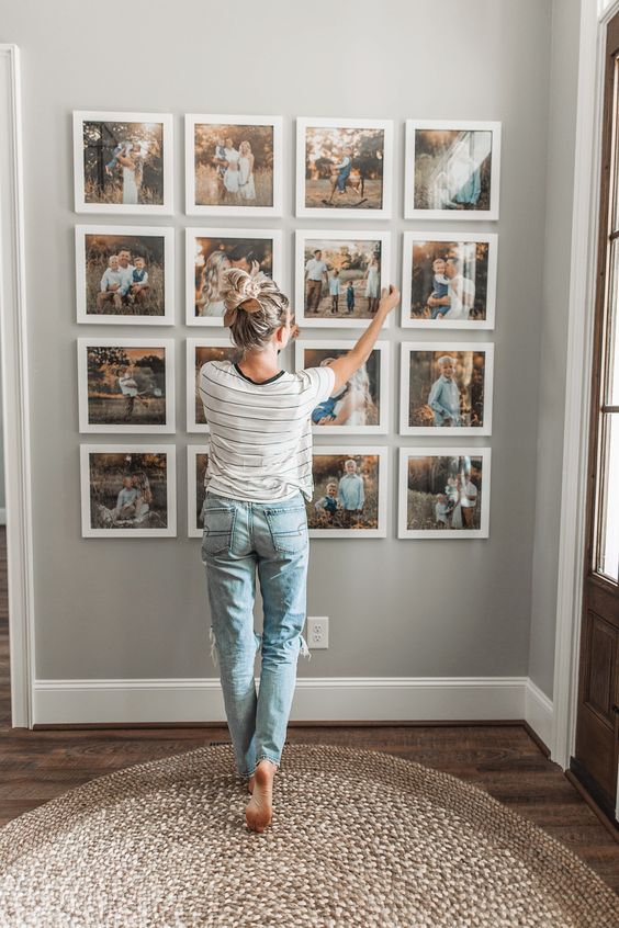 a stylish family gallery wall with color photos in matching white frames is a timeless idea