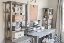 a vintage farmhouse home office with a wooden desk, cabinets and open shelves on them and a board in a frame