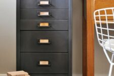 a vintage filing cabinet refinished with chalkboard paint that gives it a worn and very refined vintage feel