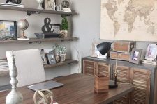 an industrial farmhouse home office with open industrial shelves, a wooden desk, a shutter door storage unit, vintage decor and monograms