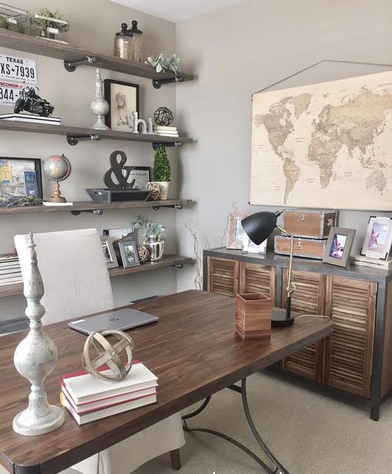 an industrial farmhouse home office with open industrial shelves, a wooden desk, a shutter door storage unit, vintage decor and monograms