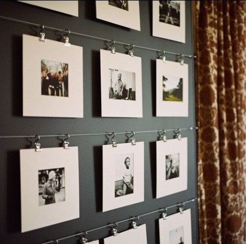metal rails attached to the wall allow you attaching as many pics as you want and change them anytime