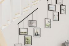 two photo rails attached to the staircase and photos hanging on them will let you comfortably show off your pics