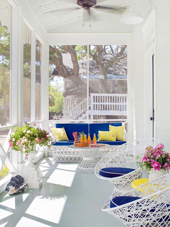 a bright modern beachy sunroom with white metal furniture with super bold upholstery, some potted blooms and seashells a bright modern beachy sunroom with white metal furniture with super bold upholstery, some potted blooms and seashells