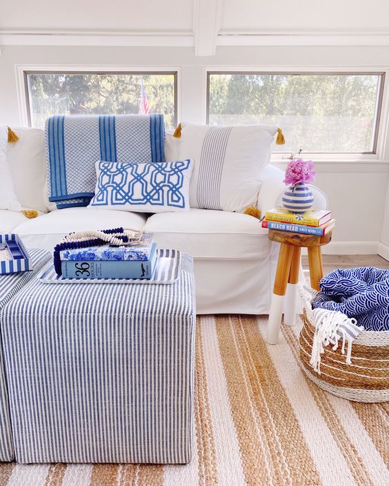 a bright modern sunroom with white and striped furniture, printed pillows and a jute rug is very cool a bright modern sunroom with white and striped furniture, printed pillows and a jute rug is very cool