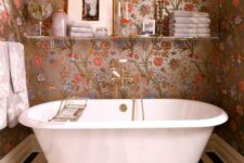 a lovely bathroom with a floral wallpaper