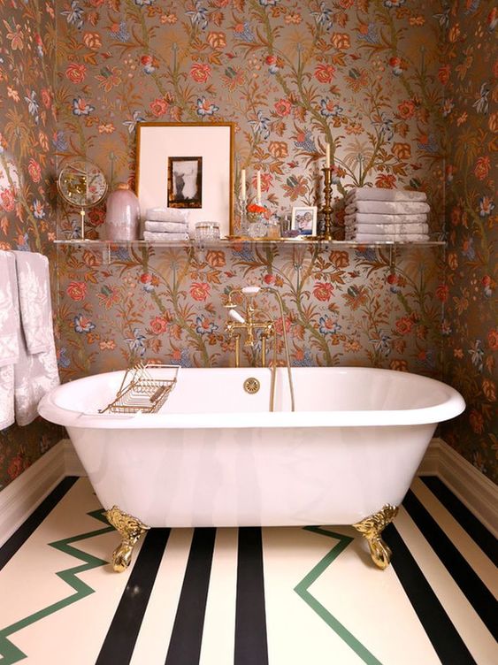 a lovely bathroom with a floral wallpaper