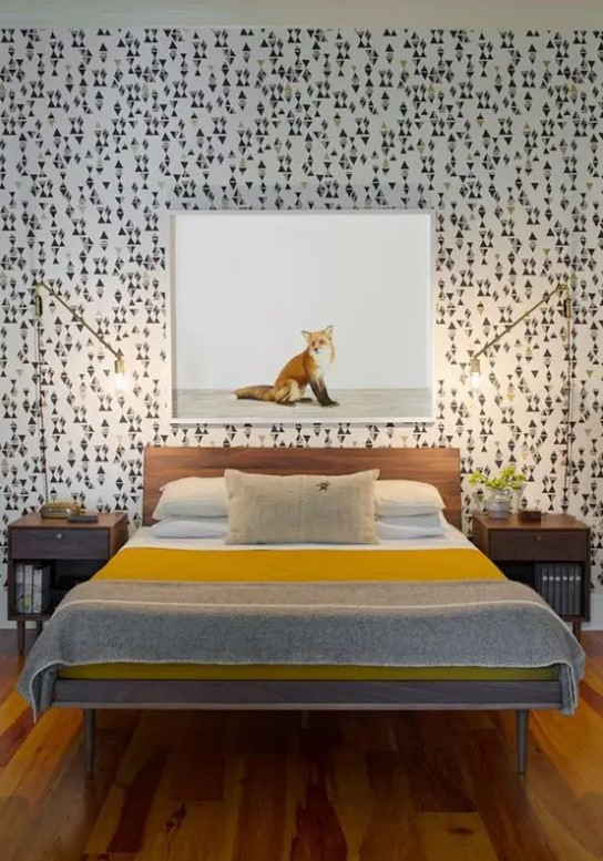 a catchy mid-century modern bedroom with geometric wallpaper, simple stained furniture and gilded table lamps