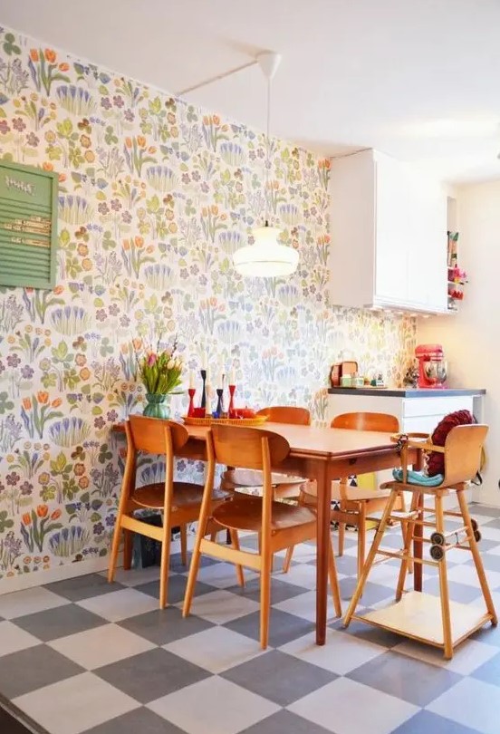 a colorful modern kitchen and dining zone accented with colorful floral wallpaper and with bright accessories for fun