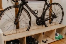 a pallet storage shelf with a bike and various stuff related stored comfortably here is a great idea for a any room