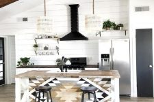a lovely kitchen with shiplap walls