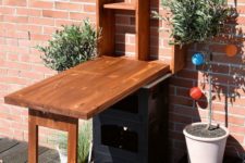 a Murphy table for outdoors can be used as a bar or or storing, decorate it with potted greenery