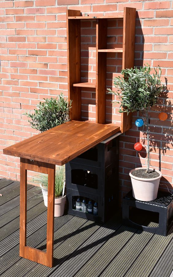 a Murphy table for outdoors can be used as a bar or or storing, decorate it with potted greenery