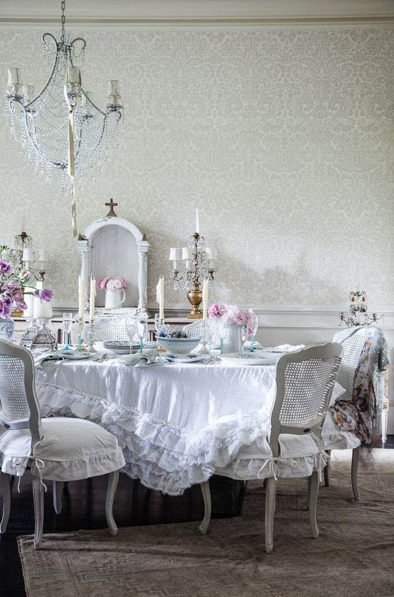 https://www.digsdigs.com/photos/2015/04/a-beautiful-vintage-dining-room-with-a-crystal-chandelier-white-furniture-a-ruffle-tablecloth-and-blooms.jpg