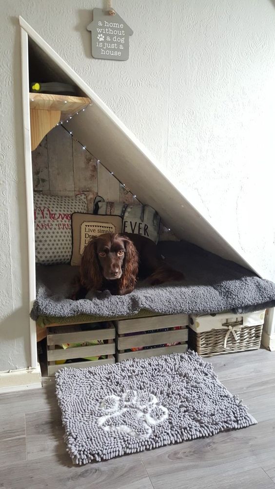 a cozy attic nook with a built-in bed, crates for storage, lights and lots of pillows plus a dog rug is an amazing idea